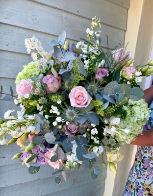 Country garden hand tied bouquet in a vase.
