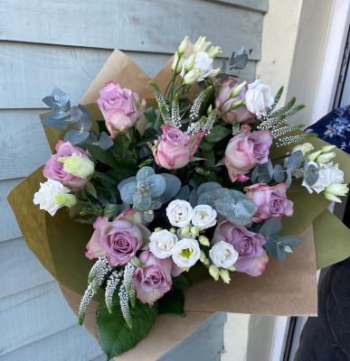 Beautiful memory lane roses, veronica and lisianthus hand tied bouquet presented in a gift box in water.