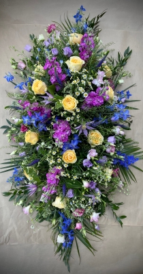 Country garden style double ended spray with scented stocks and freesias.