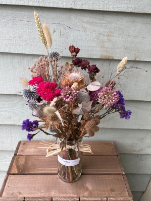 Florists choice of dried flowers arranged in a jar.