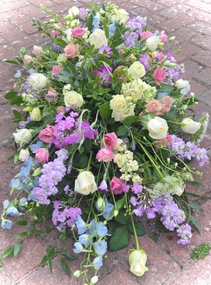 Pretty country garden style double ended spray with scented stocks.