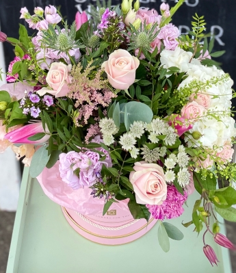 Pretty hand tied bouquet in a keepsake hat box.