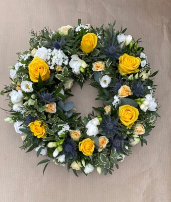 Pretty yellow and white wreath with blue thistle.