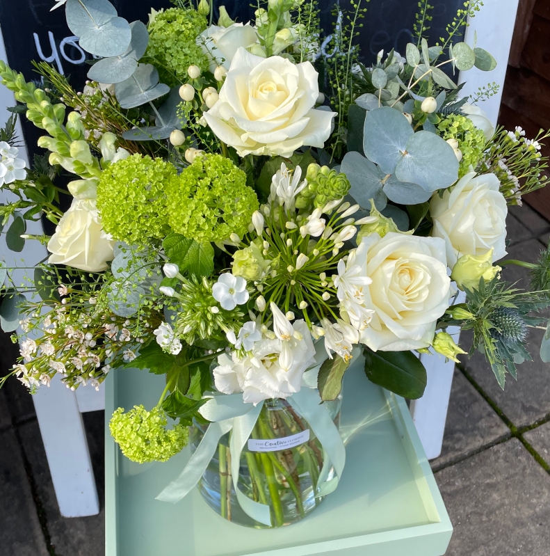 Stunning eco vase arrangement in white and green.