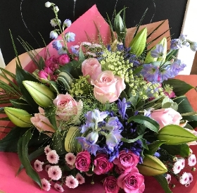 Lilies, roses and mixed flower hand tied, gift boxed bouquet in water.