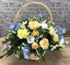 Basket arrangement in lemon, blue and white.