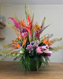 Tropical vibes luxury fish bowl vase arrangement arranged in oasis.