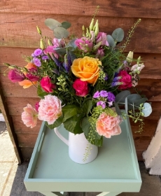 Bright and cheerful jug of flowers. Eco friendly!