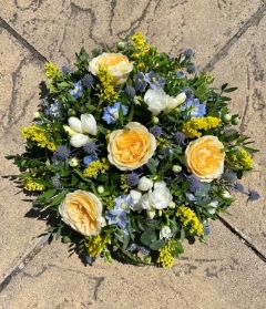 Rose, delphinium, freesia and thistle posy in oasis.