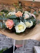 12 beautiful hand tied pastel roses presented in a gift box in water.