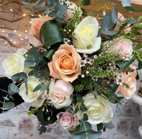 12 beautiful hand tied pastel roses presented in a gift box in water.