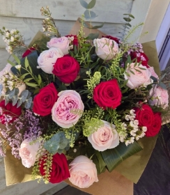 A stunning 24 rose bouquet of red and pink roses.