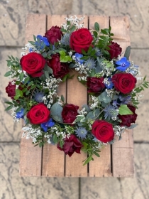 Beautiful red, white and blue wreath. (Please note tulips will be replaced with an alternative dark red flower when tulips are unavailable.