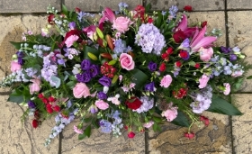 Country garden style coffin spray.