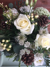 Florists choice of winter white flowers and greenery in an included eco vase.