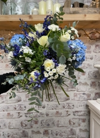 Hand tied bouquet in blue and white, gift boxed in water.