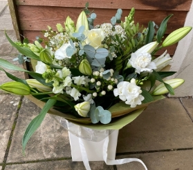 Ivory hand tied gift boxed bouquet in water.