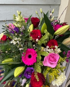 Large rose, lilies and mixed flowers hand tied bouquet in a gift box with water.