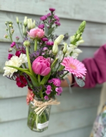 Pretty florist choice jar full of flowers.